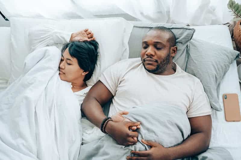 Overweight person snoring in bed